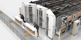Automated warehouse picking system with vertical storage units and workers packing boxes along a conveyor line.